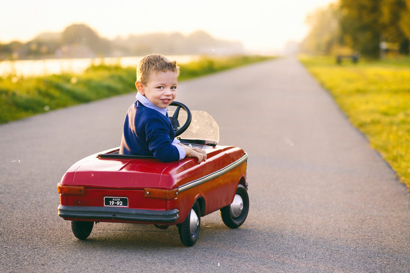 Young boy in toy car