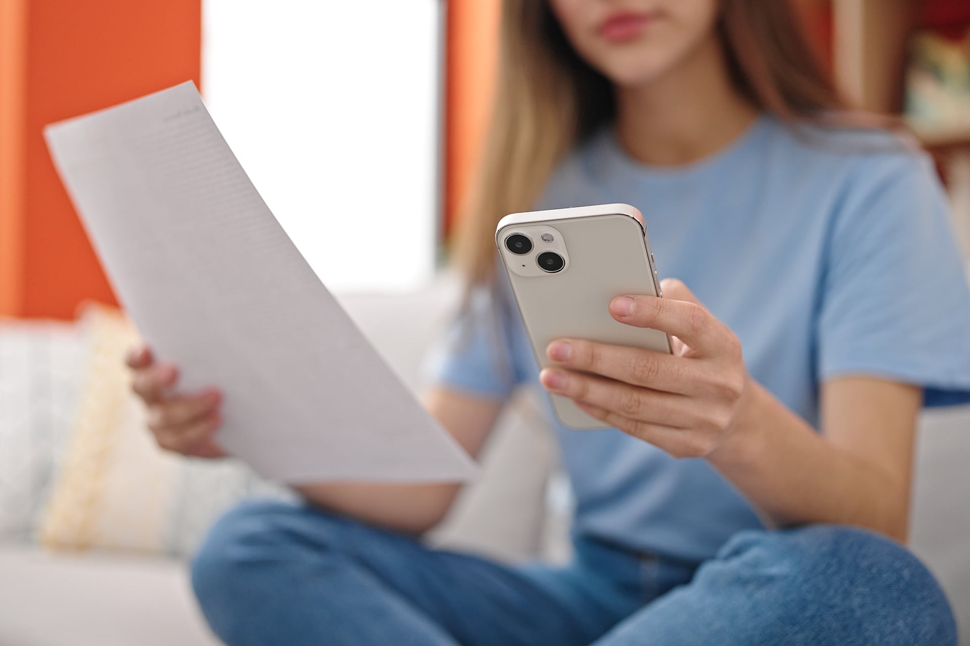 girl holding mobile and document